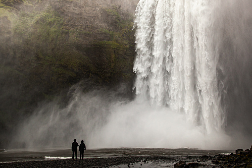 A silhouette of people near the Skogafoss in Vik, Iceland