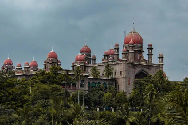 A beautiful shot of the High Court for the State of Telangana with surrounding trees in India.