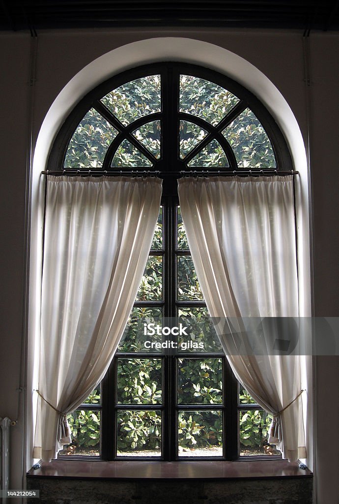 Classical window with drapes halfway drawn open  classic window with white curtain Arch - Architectural Feature Stock Photo