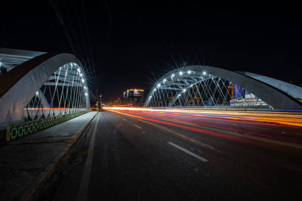 istock Expressway on the steel arch bridge at night with white lights 1442120611