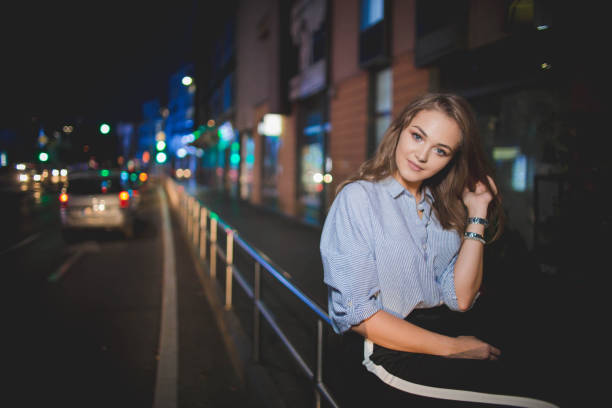istock Young beautiful blonde female posing outdoors at night 1442120710
