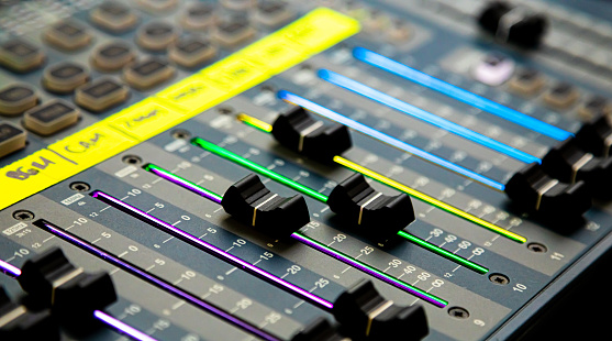 Close up of Sliders and buttons on Audio Mixing Desk at live event