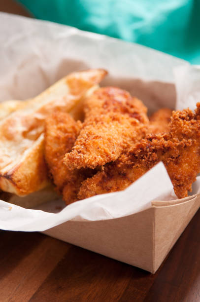 istock chicken strips and fries in a take out container 1442121373