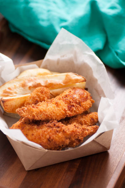 istock chicken strips and fries in a take out container 1442121389