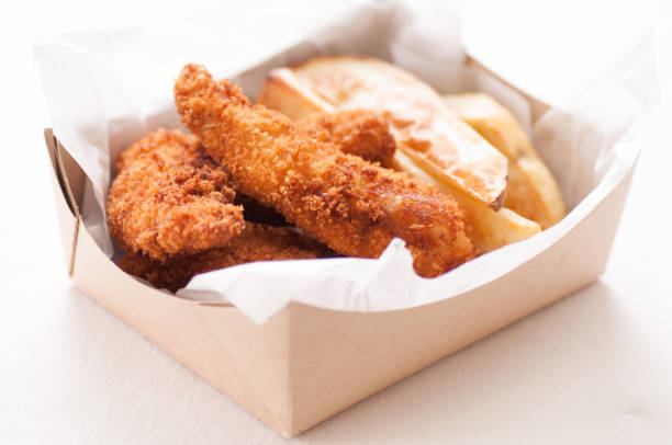 istock chicken strips and fries in a take out container 1442121391