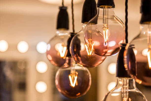 istock Selective focus shot of light bulbs hanging on the ceiling 1442122084
