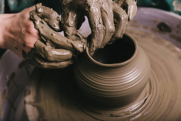istock Woman hands working on pottery wheel and making a pot. 1442122908
