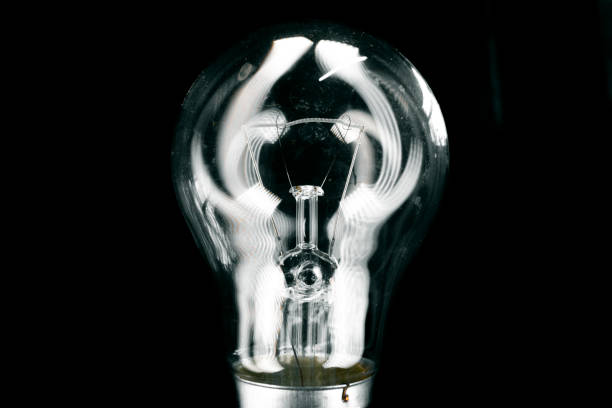istock Glass light bulb close up on black background 1442123360