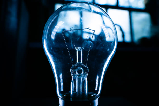 istock Glass light bulb close-up in a dark room 1442123363