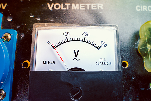 Mechanical voltmeter close up. Voltage measuring device on a gasoline generator