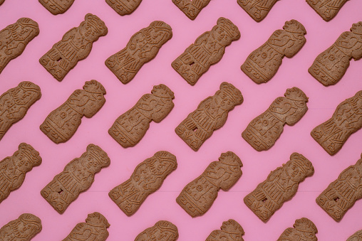 A top view of Speculaas biscuits on the pink surface