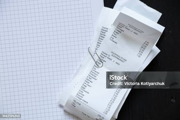 On The Table A Check From The Supermarket And Dollars Were Brought In Notebooks A Paper Receipt With Purchases Money And Checks From The Supermarket Were Brought Stock Photo - Download Image Now