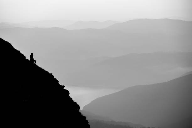 istock Silhouette of a traveler on a rock 1442124414