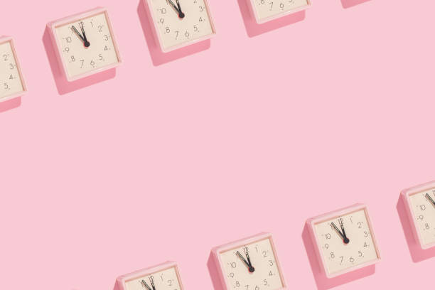 istock New Year countdown creative trendy copy space pattern made with pink clocks on pastel pink background. 80s or 90s retro aesthetic fashion holiday concept. Minimal New Year party idea. 1442124611