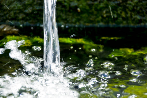 closeup shot of splashing spring water - groundwater imagens e fotografias de stock