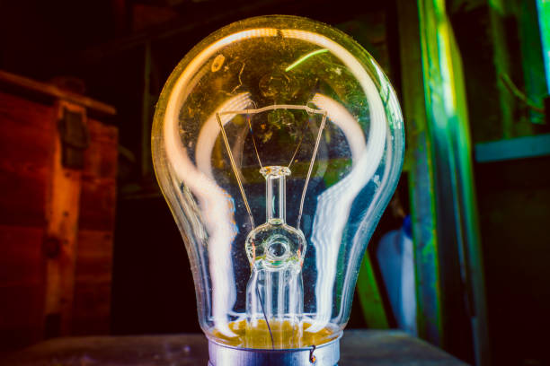 istock Old incandescent light bulb close-up on colorful lighting 1442125871