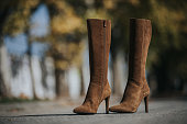Fashionable brown suede knee-high boots outdoors