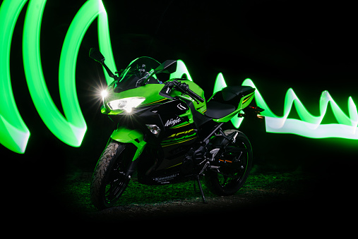 Kristiansand S, Norway – October 15, 2020: A Kawasaki ninja with green led lights with long exposure outdoors