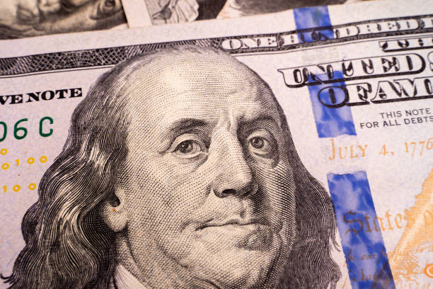 istock Close-up image of Benjamin Franklin on one hundred us dollar bill 1442127126