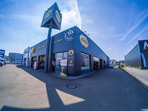 Le Mans, France – September 26, 2021: The front view of the Midas workshop specializing in car repair in Le Mans, France