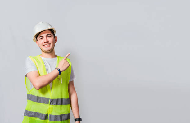 istock Engineer man pointing to side. Builder engineer pointing finger to the right isolated, Portrait of engineer man pointing aside, Construction engineer with vest pointing at an advertisement 1442131083