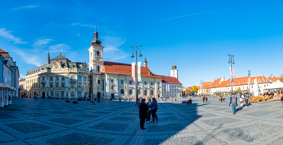 Sibiu town, Romania - 21 October, 2022: People walking at Hermannstadt the town square at Sibiu. Transylvania, Romania, Europe.