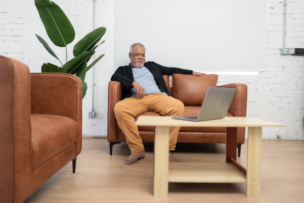istock Happy senior investor with mobile device 1442133238