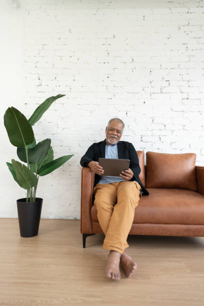 istock Happy senior investor with mobile device 1442133241