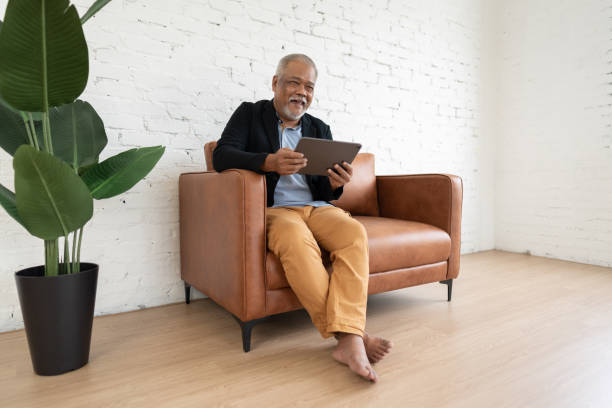 istock Happy senior investor with mobile device 1442133263
