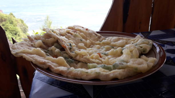istock Delicious mendoan banyumas made from fried tempe on plate with beautiful beach view 1442133360