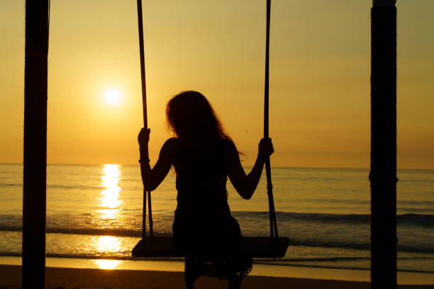 istock Young Asian women swing on the beach 1442133389