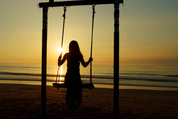 istock Young Asian women swing on the beach 1442133393