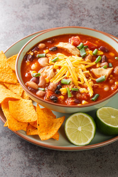 istock Taco chicken soup served with lime and tortilla chips close-up in a plate. Vertical 1442134122