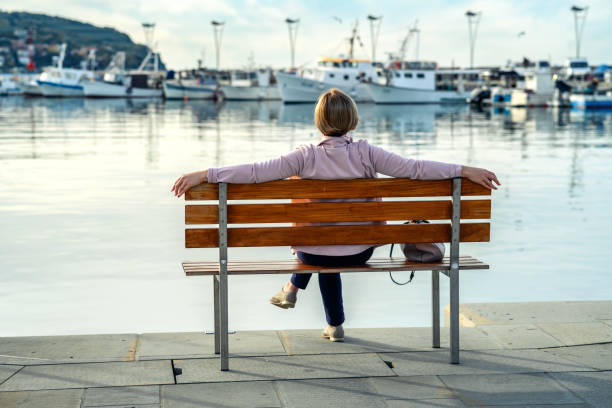 Mature woman relaxing at the harbor