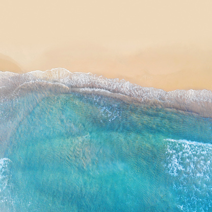 Horizon splits vibrant blue sky and wide sandy beach