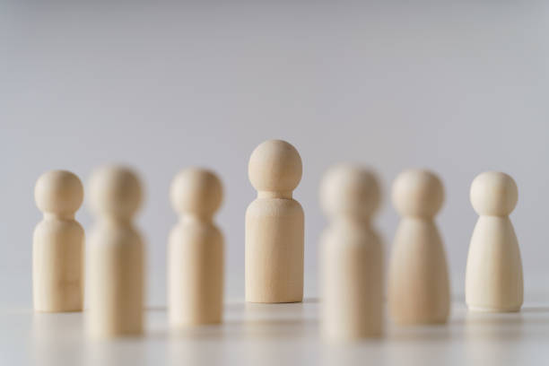 istock Wooden figures on white background. teamwork, leadership and business team creative thinking and human resources, Recruitment employee concept 1442134488
