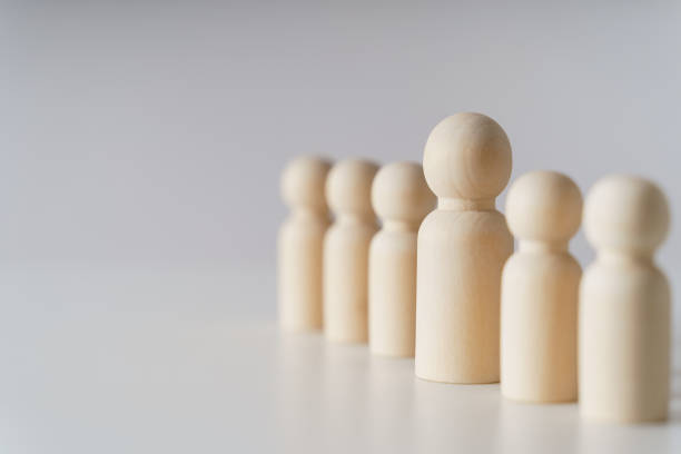 istock Wooden figures on white background. teamwork, leadership and business team creative thinking and human resources, Recruitment employee concept 1442134492