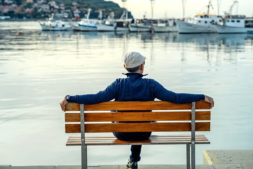 Mature man relaxing at the harbor