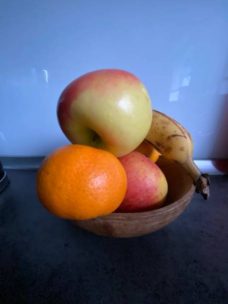 istock Apples, banana and clementine in a bowl 1442138467