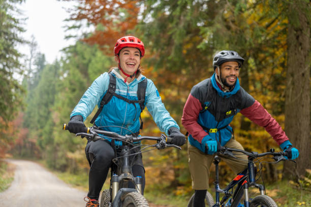 istock Man and woman riding mountain bikes in forest 1442139774