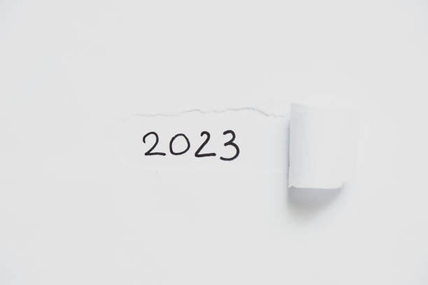 istock 2023 written on white torn paper, happy new year 1442140010