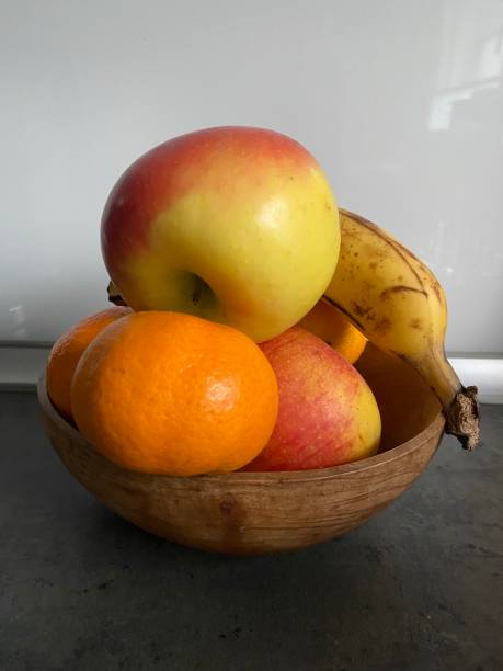 istock Apples, banana and clementine in a bowl 1442140222