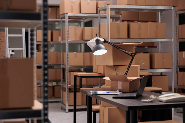 istock Empty warehouse delivery department full with rows of shelves with cardboard boxes 1442140421