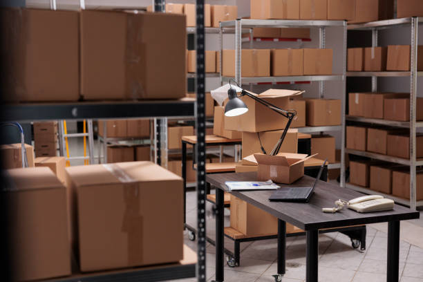istock Empty huge distribution storehouse in logistic center with high shelves full with cardboard boxes 1442141088
