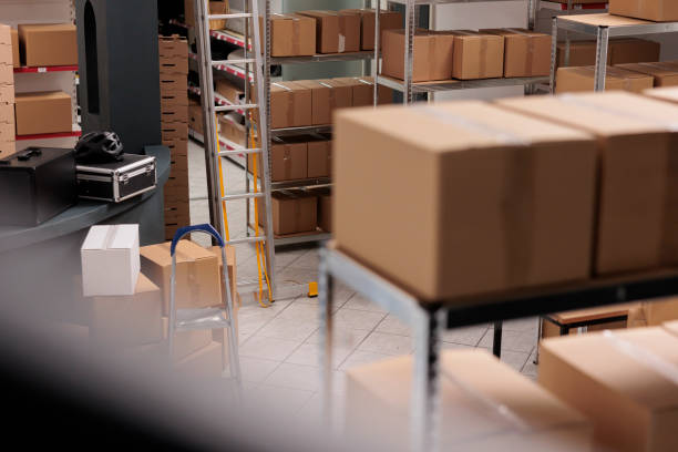 istock Empty huge distribution storehouse equipped with high shelves fill with carton boxes 1442141193