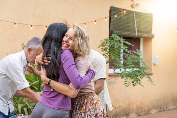 istock Multiethnic middle aged friends greet each other and huddle together happily. 1442141246
