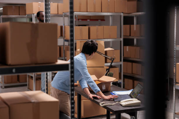istock Warehouse employee checking shipping details on laptop computer before start packing clients orders 1442141256
