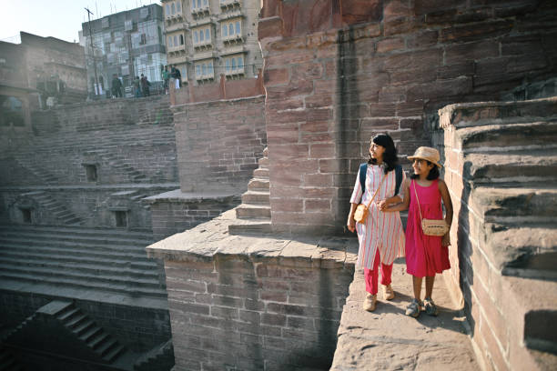 istock Tourist mother and daughter holding hands exploring  a step well 1442141325