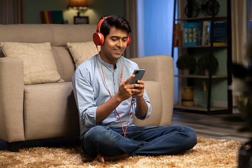 Man watching videos on tablet with headphones