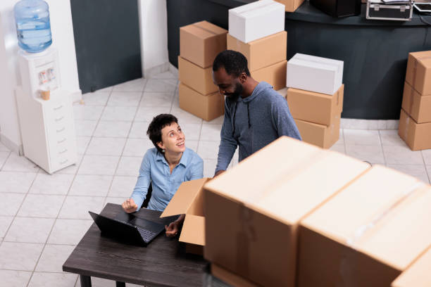 istock Top view of diverse team discussing about shipping logistics while looking at cargo stock on laptop computer 1442141782
